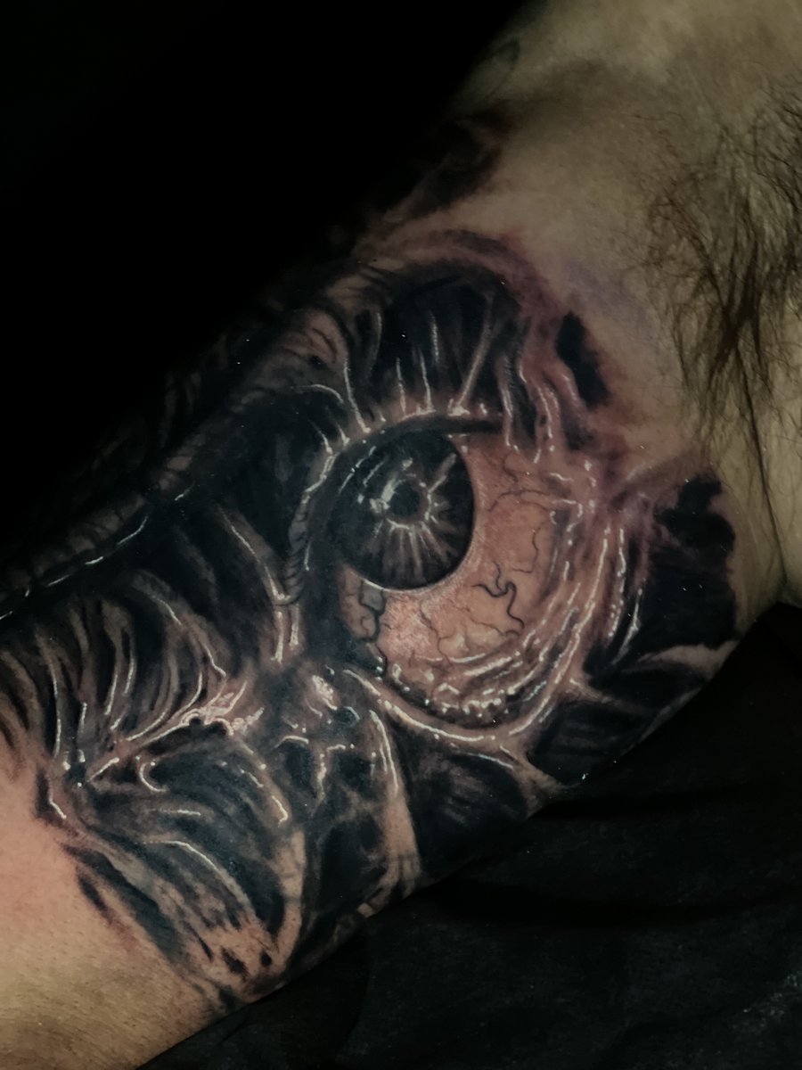 Detailed black and gray biomechanical horror eyeball tattoo on inner arm by Zack Ross, custom tattoo artist Kyle TX near Austin