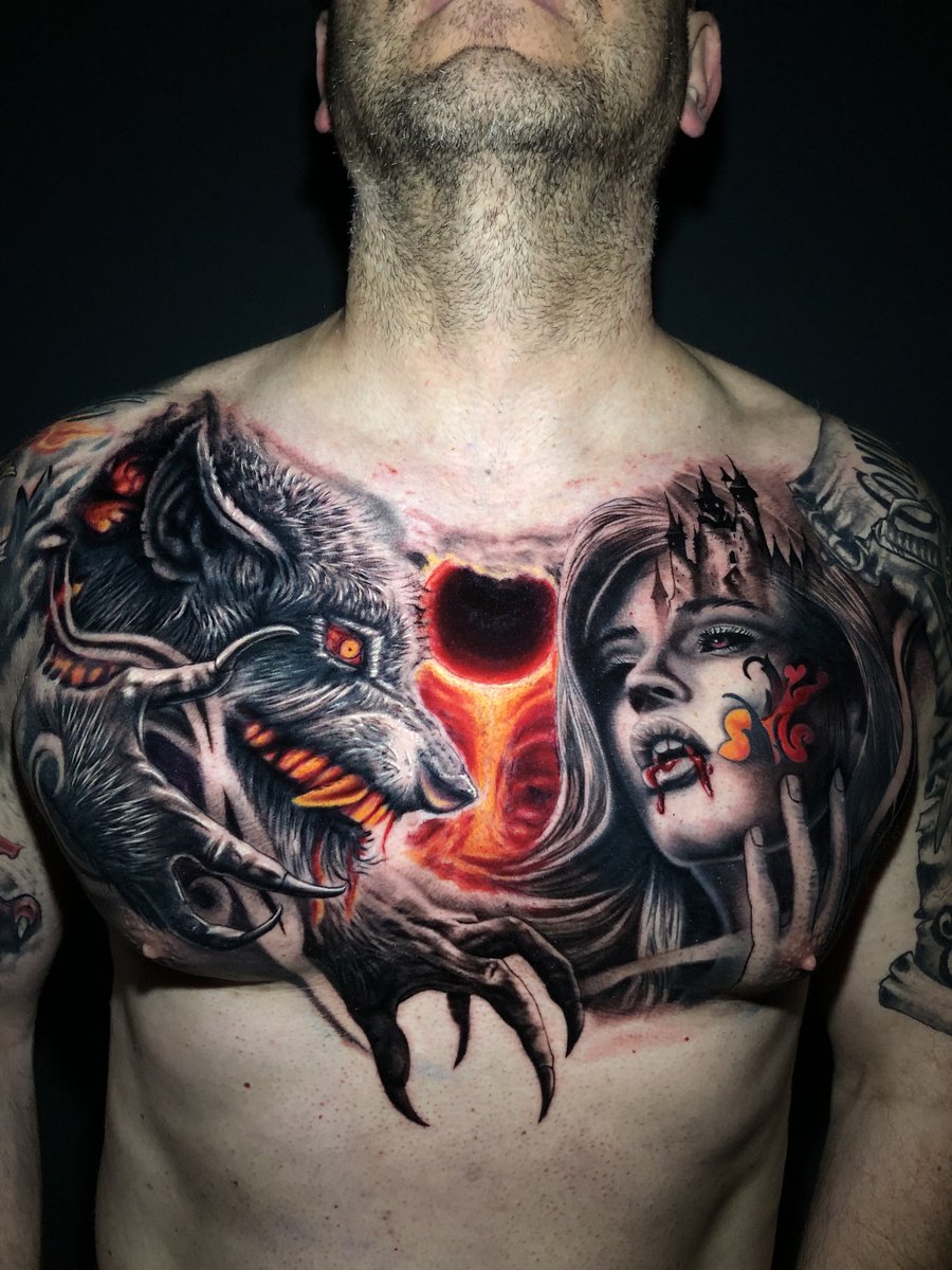 Large scale black and gray chest piece tattoo featuring a snarling wolf and female vampire portrait with glowing red accents by Zack Ross, Austin Texas tattoo artist based in Kyle TX