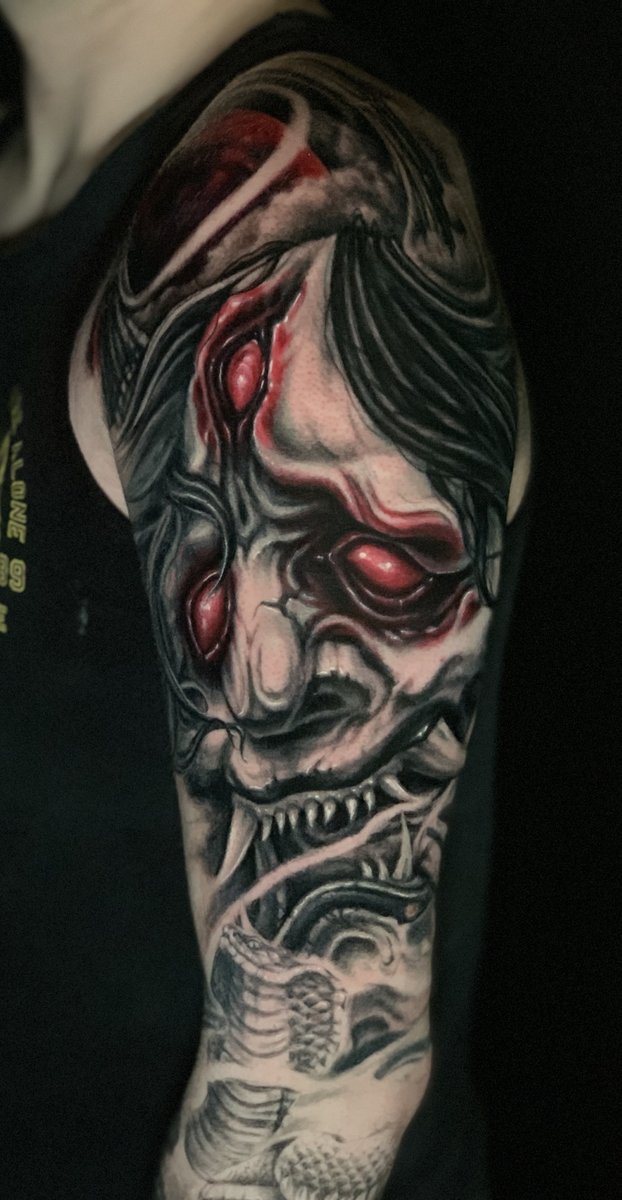 Japanese neo-traditional Hannya demon mask upper arm tattoo with snake and red accent details by Zack Ross, tattoo artist Kyle TX near Austin Texas