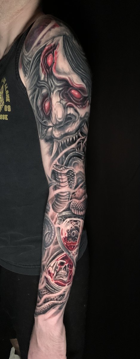 Black and gray full sleeve tattoo featuring Hannya demon skull, cobra snake, and hourglass with skulls with red accents by Zack Ross, large scale sleeve tattoo artist Kyle TX near Austin
