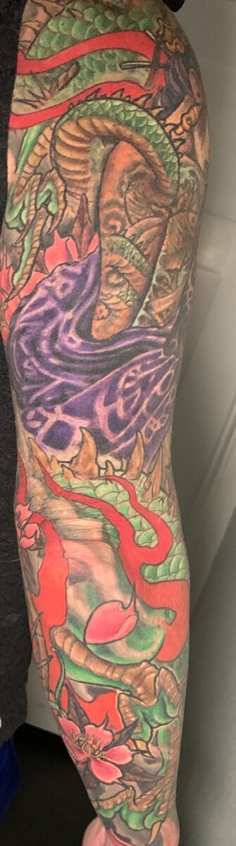 Bold color tattoo work by Zack Ross showing saturated illustrative style, custom sleeve tattoo Kyle TX near Austin Texas
