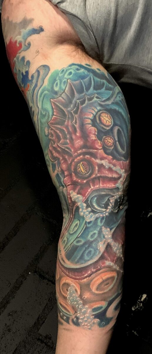 Color sleeve tattoo by Zack Ross, full arm coverage with vivid saturated color, large scale tattoo artist Kyle TX near Austin