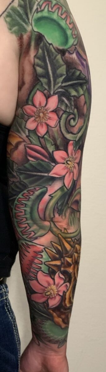 Color sleeve tattoo by Zack Ross, vivid saturated color work across full arm coverage, large scale tattoo artist Kyle TX near Austin